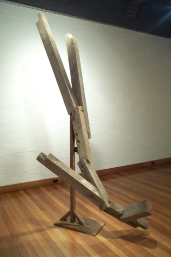 The Fall, hardwood with iron base. Photograph from a solo exhibition entitled The Movement of the Body in a Stationary Object, Ivan Dougherty Gallery, Sydney, Australia 2002.